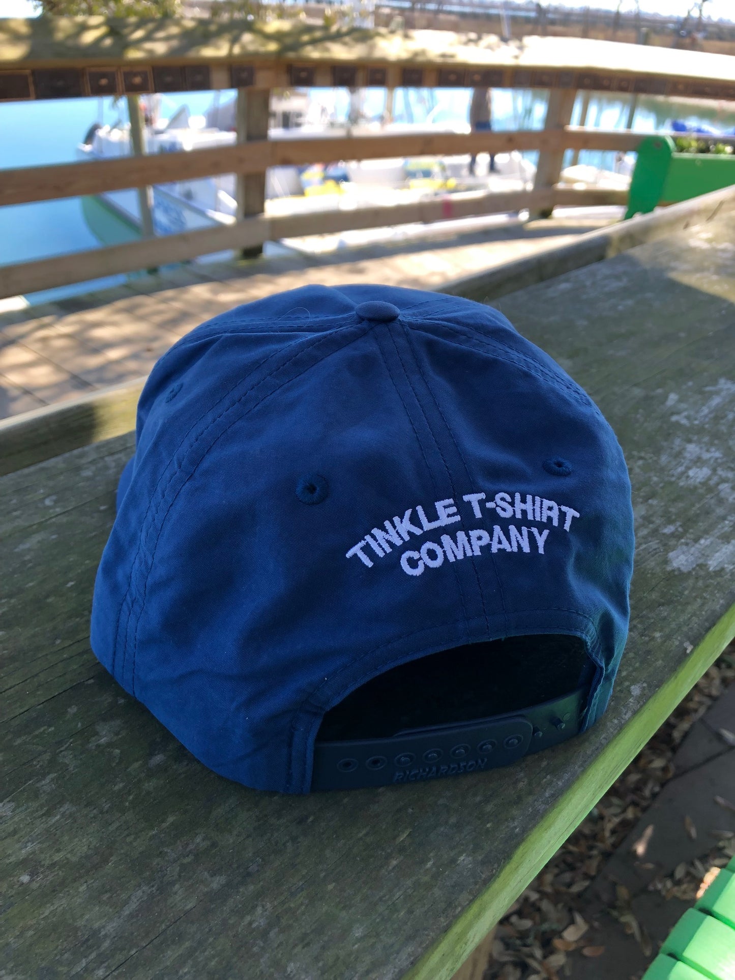 back of golf tinkler hat, says Tinkle T shirt Company embroidered