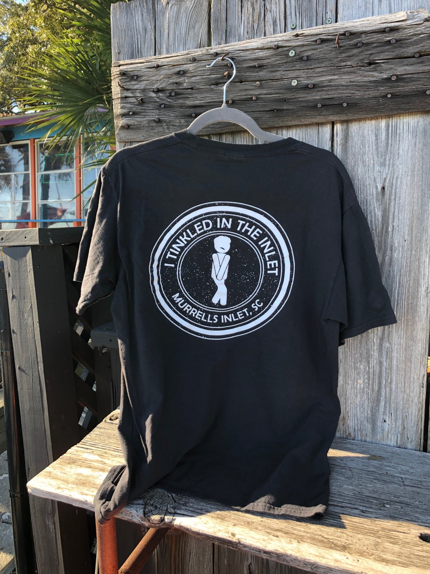 back of i tinkled in the inlet murrells inlet t shirt photographed at the marshwalk.
