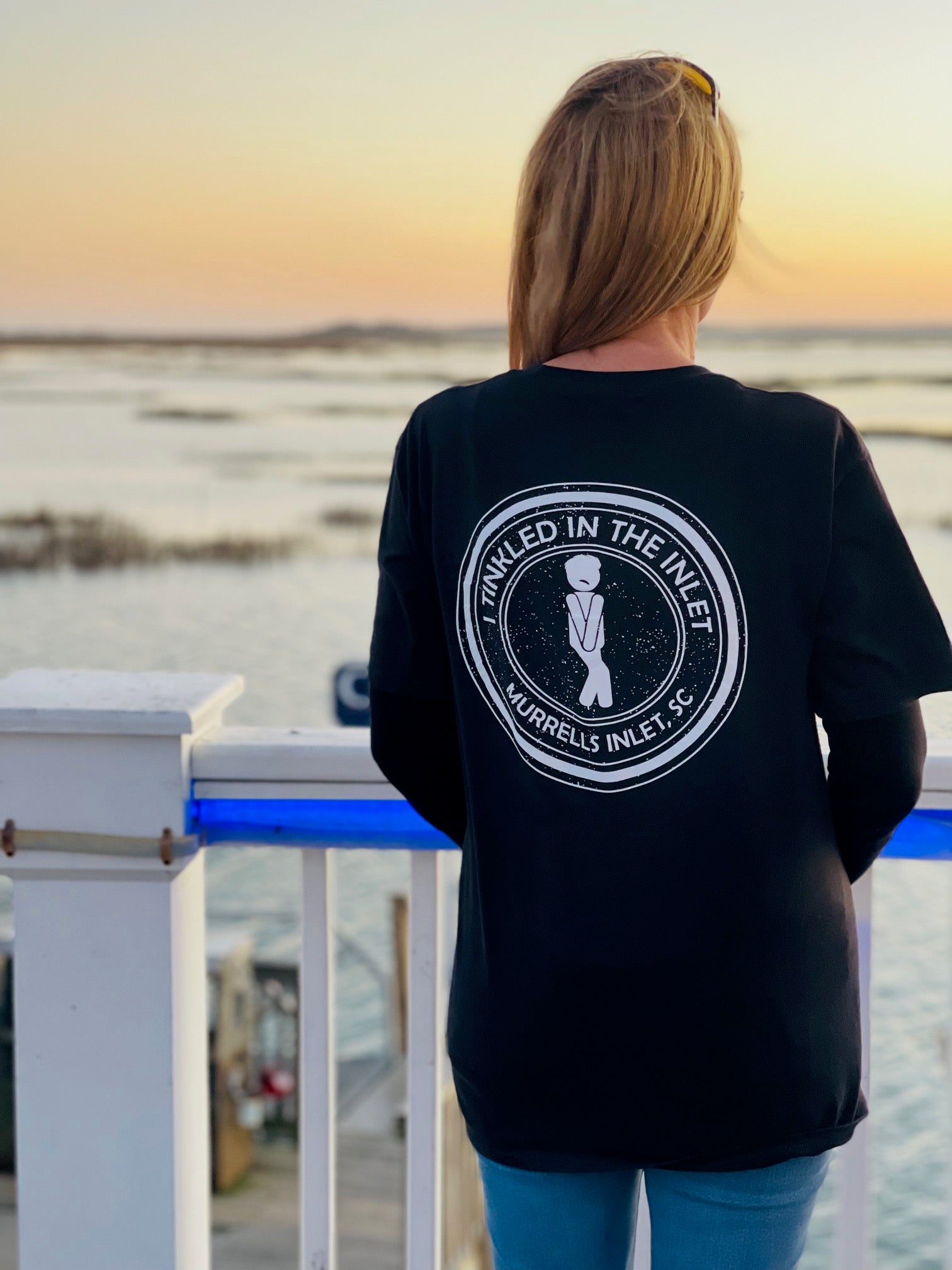 woman lookng at ocean wearing I tinkled in the inlet t shirt