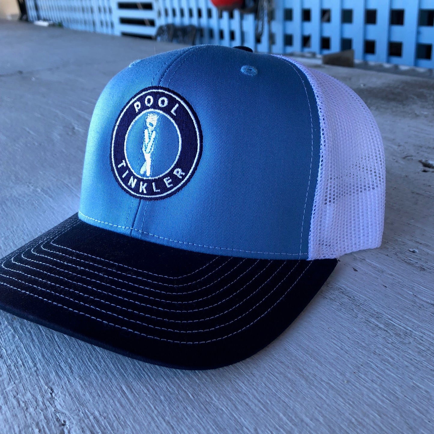 pool tinkler baseball cap on the ground