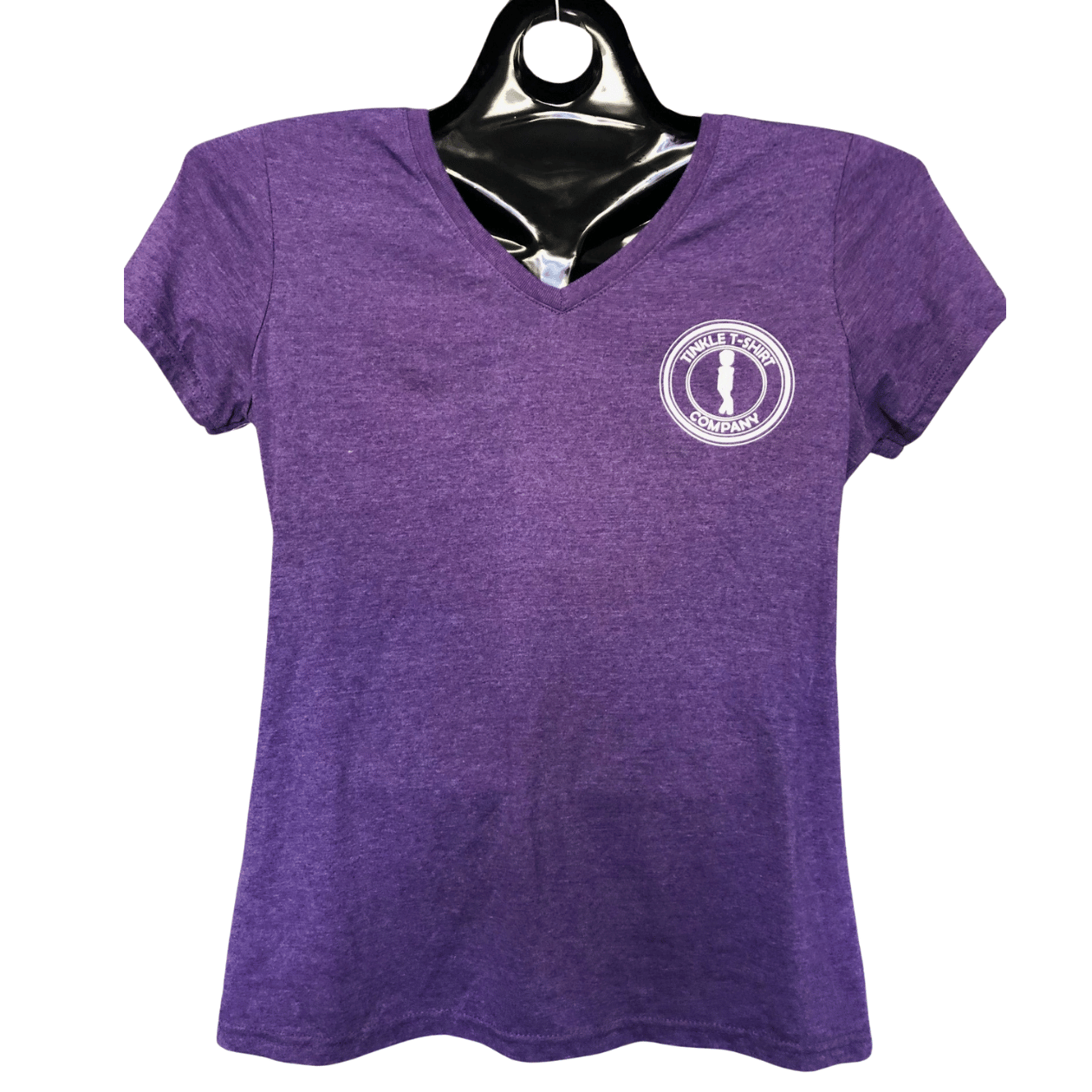 Front of women’s purple heather v-neck shirt with Tinkle T-Shirt Company logo on a hanger