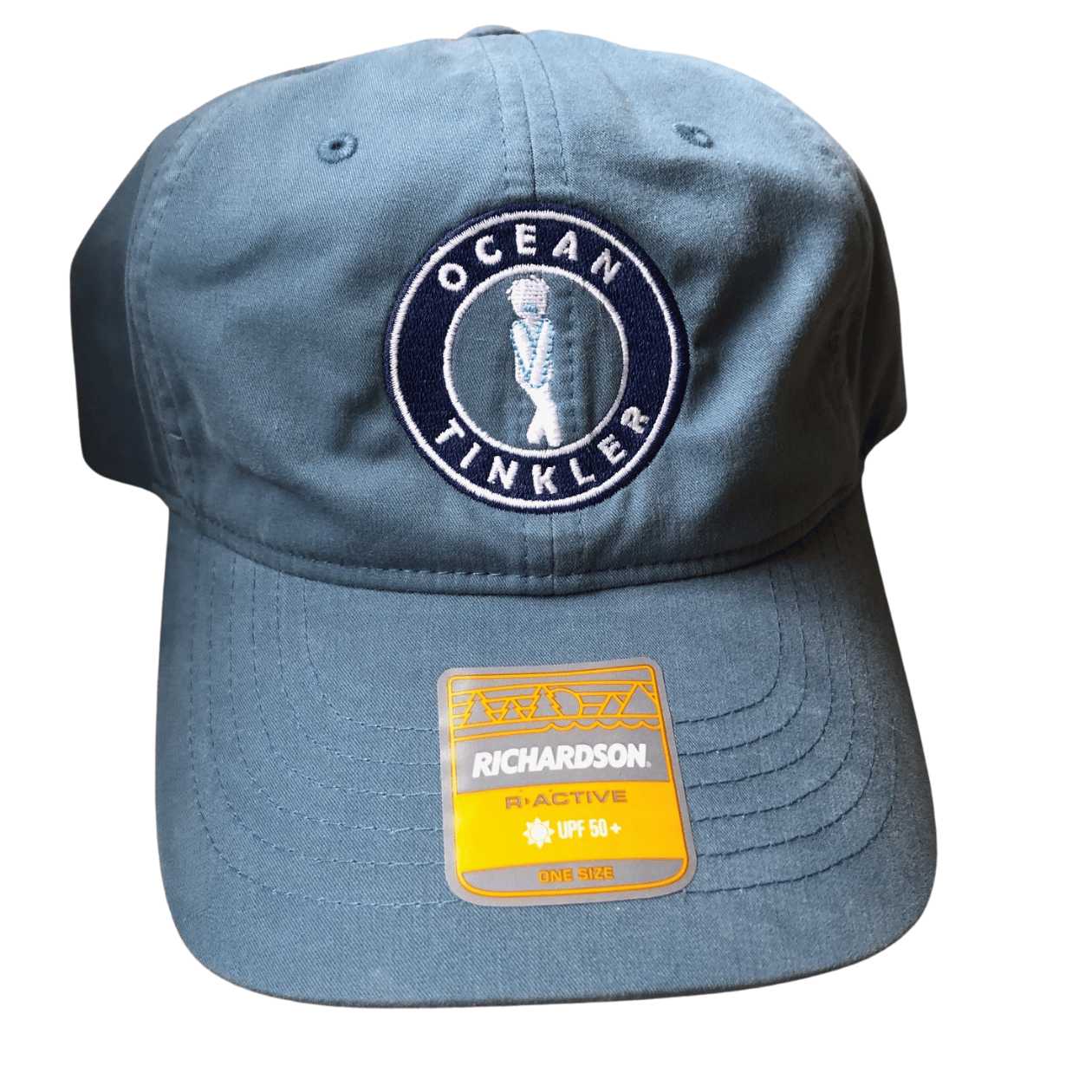 Front view of light blue Ocean Tinkler performance hat with embroidered logo